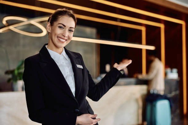 Hospitality professional welcoming guests at a modern hotel reception
