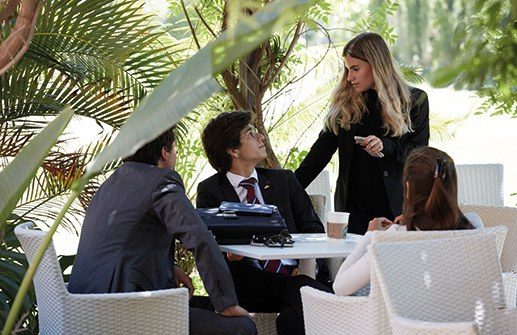 Les Roches Marbella students working together in an outdoor campus setting